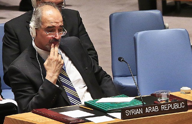 Syria U.N. ambassador Bashar Ja'afari listens after a U.N. Security Council vote on referring the Syrian crisis to the International Criminal Court for investigation of possible war crimes, Thursday, May 22, 2014.  The resolution was vetoed with Russia and China, two of the council's permanent members, voting against the resolution.   (AP Photo/Bebeto Matthews)