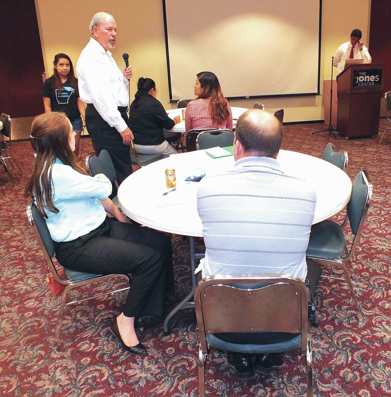 STAFF PHOTO JOSE LOPEZ Jon Comstock, former Benton County circuit judge, speaks Thursday as an audience member at the Racial Disparity in the Arkansas Criminal Justice System forum at The Jones Center in Springdale.