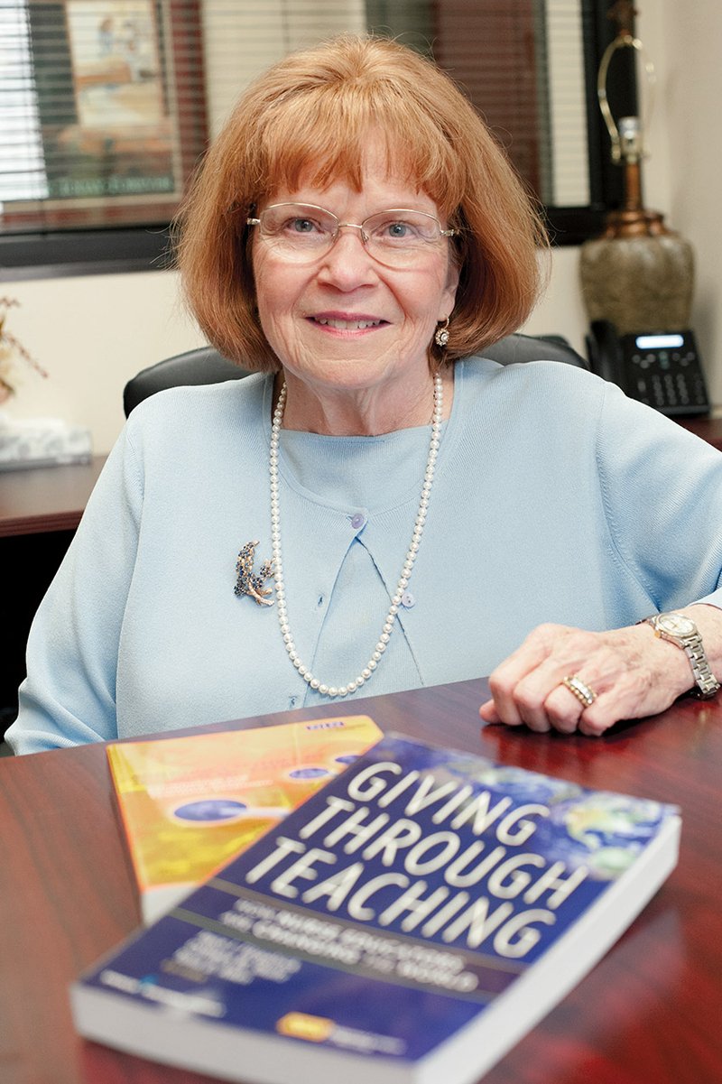 Cathleen Shultz, dean of the Carr College of Nursing at Harding University in Searcy, shows the two books she has written. She has served as dean since 1980 and will step down from the position effective June 1 to take a yearlong sabbatical, then will return to Harding as a full-time professor of nursing.