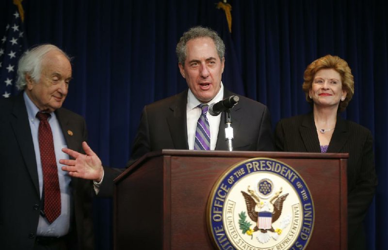 U.S. Trade Representative Mike Froman, Rep. Sander Levin, D-Mich., and Sen. Debbie Stabenow, D-Mich., speak to reporters regarding a World Trade Organization case involving China and the U.S. auto industry, Friday, May 23, 2014. (AP Photo/Charles Dharapak)