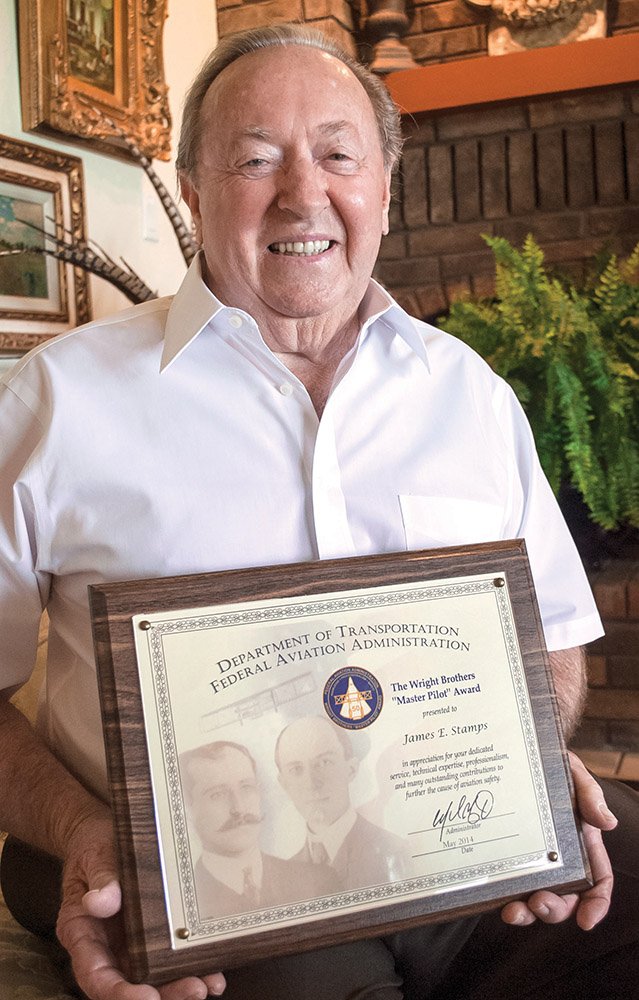 Jim Stamps, 83, at his home in Russellville, holds The Wright Brothers Master Pilot Award he received May 10 for his dedication and service to aviation safety. The honor is given to pilots who have 50 or more continuous years as a pilot without incident.