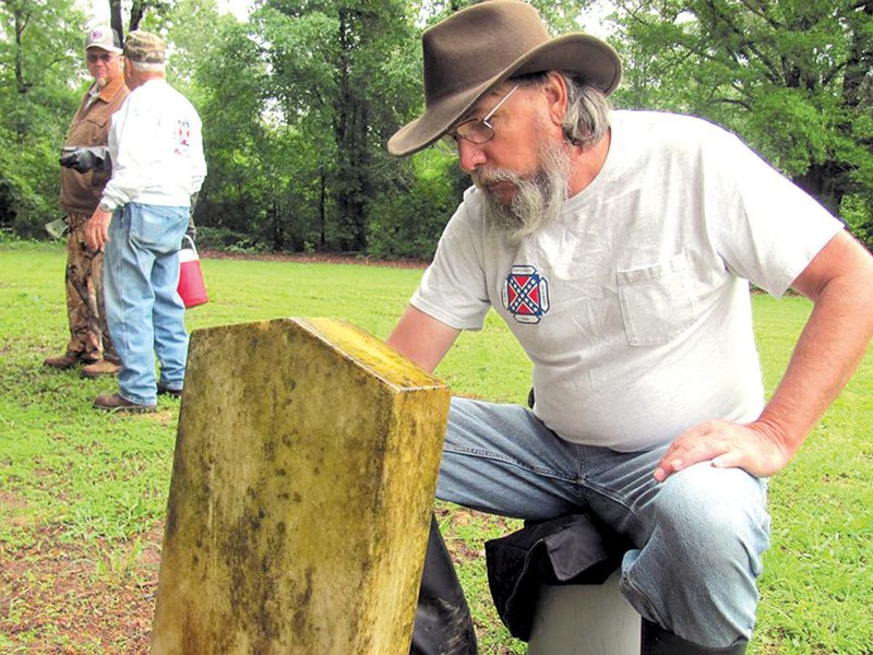 Tom Bird of the Sons of Confederate Veterans works at the Dogwood Cemetery to refurbish headstones.