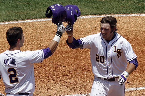 LSU's Conner Hale (20) celebrates with Tyler Moore (2) after hitting a home run against Arkansas during the second inning at the Southeastern Conference NCAA college baseball tournament on Saturday, May 24, 2014, in Hoover, Ala. (AP Photo/Butch Dill)