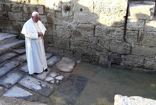 Pope Francis prays Saturday at the site on the Jordan River where Jesus is believed to have been baptized. In Amman, Jordan, the first stop of a three-day Middle East visit, the pope called for an end to the civil war in Syria. 