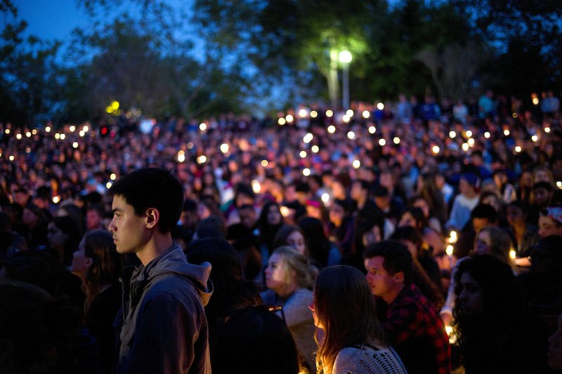 People gather at a park for a candlelight vigil to honor the victims of Friday night's mass shooting on Saturday, May 24, 2014, in Isla Vista, Calif. Sheriff's officials say Elliot Rodger, 22, went on a rampage near the University of California, Santa Barbara, stabbing three people to death at his apartment before shooting and killing three more in a crime spree through a nearby neighborhood.