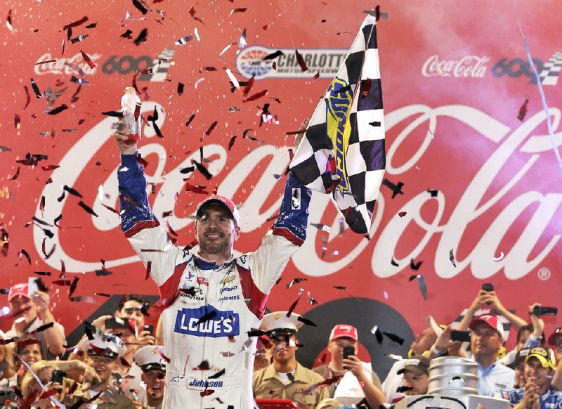 Jimmie Johnson celebrates in Victory Lane after winning the NASCAR Sprint Cup series Coca-Cola 600 auto race at Charlotte Motor Speedway in Concord, N.C., Sunday, May 25, 2014. (AP Photo/Chuck Burton)