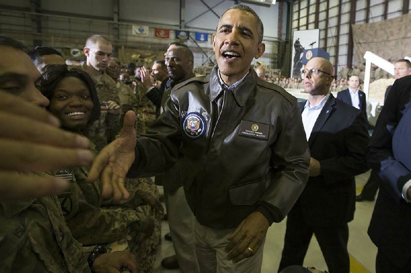 President Barack Obama shakes hands during a troop rally at Bagram Air Field during an unannounced visit, on Sunday, May 25, 2014, north of Kabul, Afghanistan. (AP Photo/ Evan Vucci)
