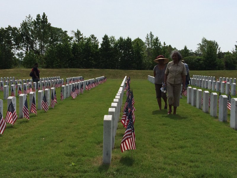 Families walk through the rows of tombstones at the Arkansas State Veterans Cemetery on Memorial Day. 