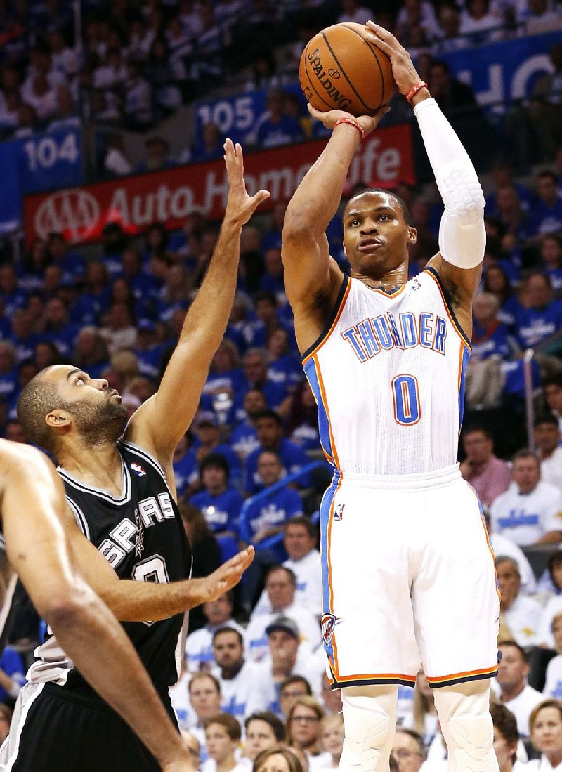 Oklahoma City guard Russell Westbrook (0) shoots over San Antonio’s Tony Parker (left) in the first quarter of the Thunder’s 105-92 victory in the NBA Western Conference final in Oklahoma City. Westbrook scored 40 points and had 10 assists in the victory. 
