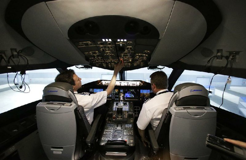 American Airlines pilots work inside a Boeing 787 flight simulator earlier this month in Fort Worth. The airline’s pilots will spend time at the controls in the simulator this year before they begin flying the 787 next year. 