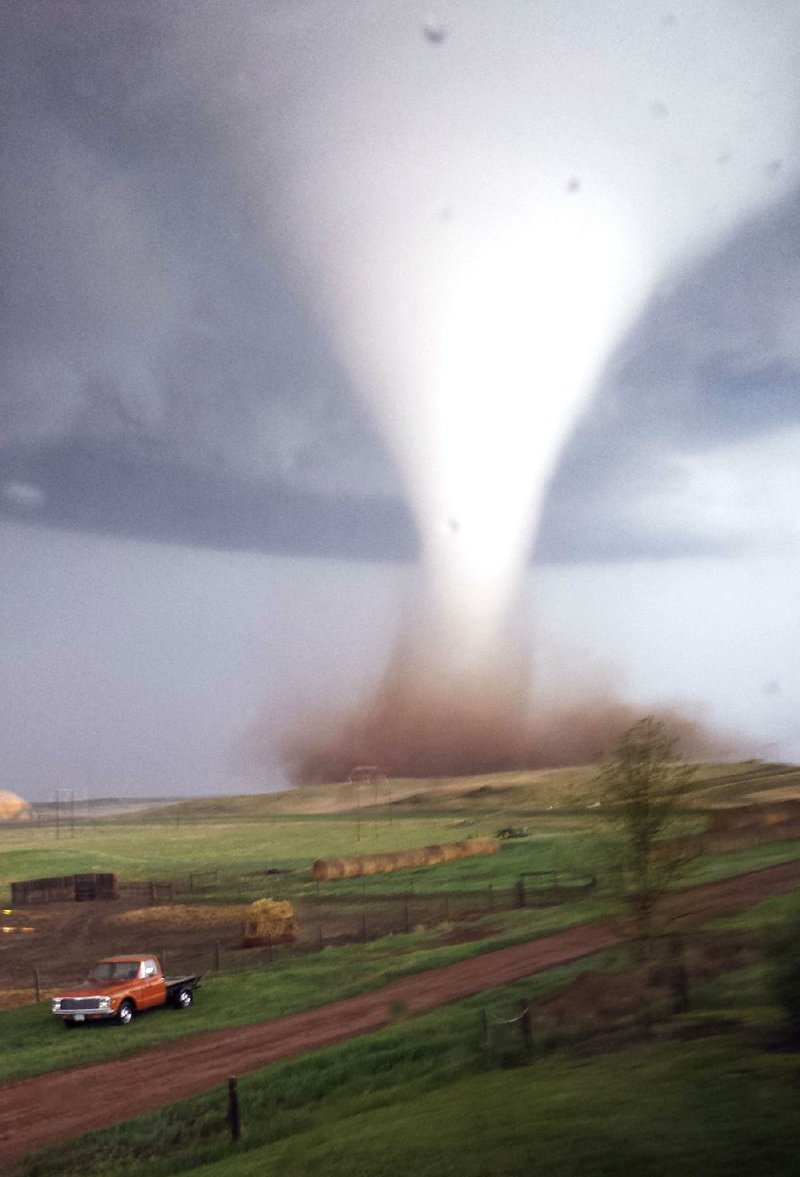 A tornado touches down Monday on its path toward Watford City, N.D., where it struck a workers’ camp in the heart of the state’s booming oil patch, injuring nine people, including a 15-year-old girl who was listed in critical condition.