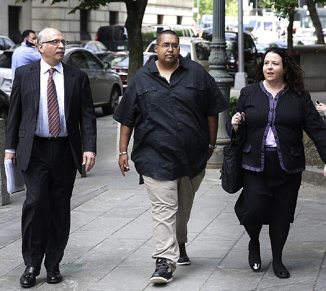 Hector Xavier Monsegur (center) arrives at his sentencing hearing Tuesday in New York with members of his legal team. 