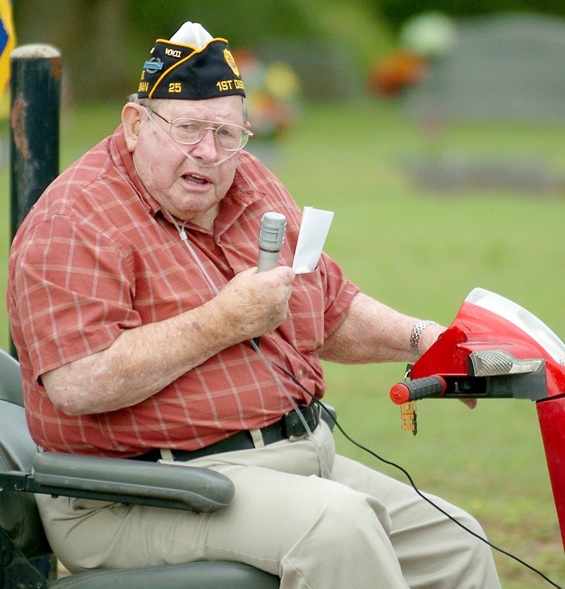 Tom Bass of Gravette, a WWII veteran, addressed the crowd at Memorial Day services on Monday and read a poem entitled &#8220;I Am Old Glory&#8221; by Howard Schnauber.
