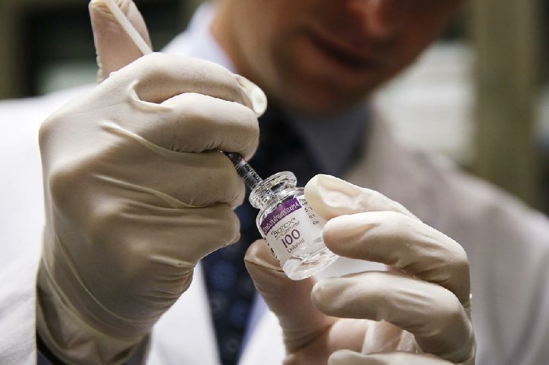 A doctor draws Botox into a syringe before administering it to a patient in Redondo Beach, Calif., in April. Valeant Pharmaceuticals increased its cash bid Wednesday to buy Botox maker Allergan Inc. 