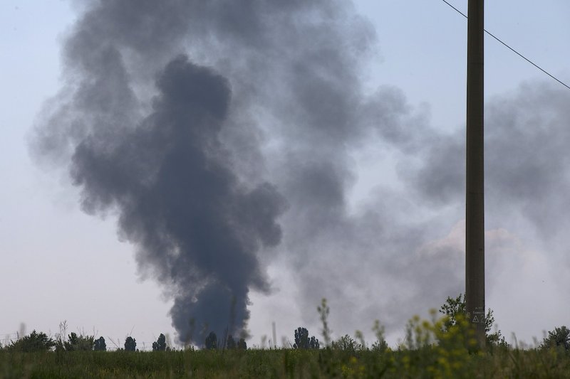 Black smoke rises from a shot down Ukrainian Army helicopter outside Slovyansk, Ukraine, Thursday, May 29, 2014. Rebels in eastern Ukraine shot down a government military helicopter Thursday amid heavy fighting around the eastern city of Slovyansk, killing several soldiers including a general, Ukraine's acting President Oleksandr Turchynov said.