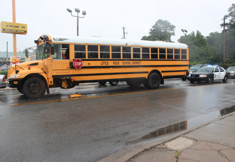 A police car sits behind a school bus after a hit-and-run accident Thursday morning in Little Rock.