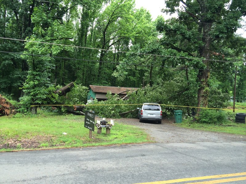 An oak tree fell Thursday morning on a home at 9417 Crystal Hill Road in North Little Rock, temporarily trapping an unknown number of people inside.