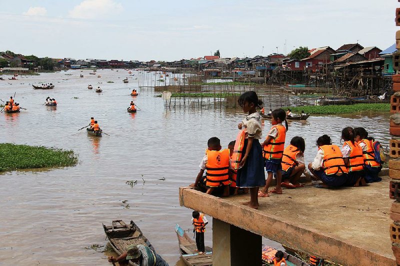 Children in Cambodia along Tonle Sap Lake get to school via canoe.