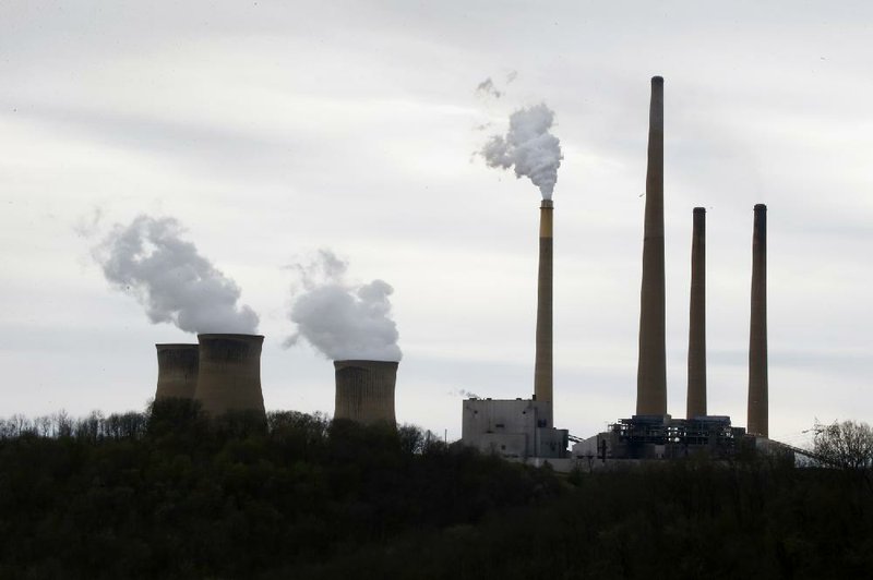 The stacks of the Homer City Generating Station in Homer City, Pa., tower over the coal-fired power plant. A White House report released Thursday says a significant increase in domestic natural gas production and reduced oil consumption are helping the United States advance its economic and environmental goals. 