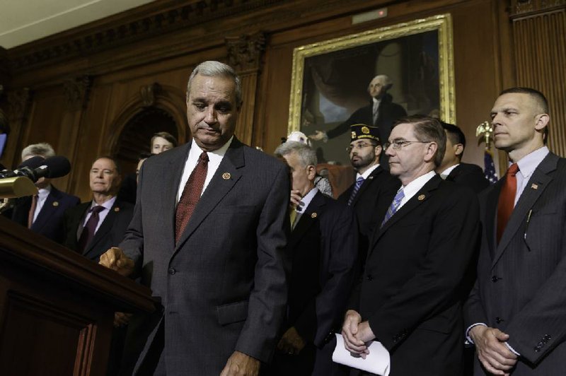 Surrounded by veterans and GOP House members, Rep. Jeff Miller, R-Fla., (left) chairman of the House Veterans Affairs Committee, finishes a statement Thursday calling for changes in the veterans health-care system. 