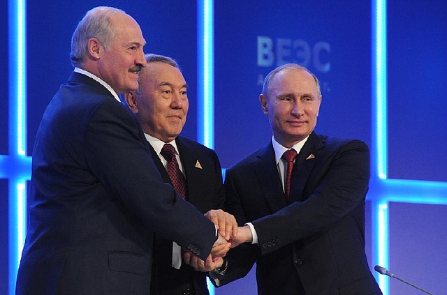 Presidents Alexander Lukashenko of Belarus (from left), Nursultan Nazarbayev of Kazakhstan and Vladimir Putin of Russia join hands Thursday after signing an economic agreement in Astana, Kazakhstan. 