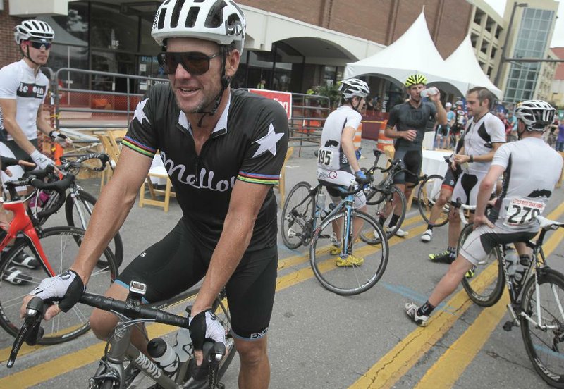 Lance Armstrong (left) visits with cyclists at the finish line Saturday during the Little Rock Gran Fondo. Armstrong, who was stripped of his seven Tour de France titles in 2012, was one of 250 cyclists who rode along a 66-mile route in the inaugural event. 