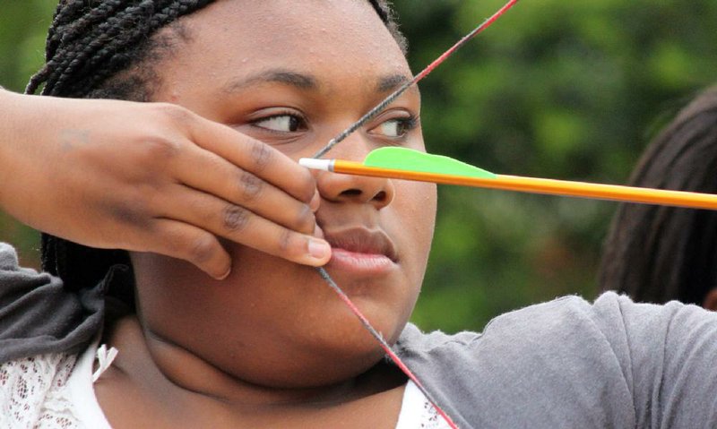 Archery skills are developed through practice, discipline and concentration, as Selena Evans demonstrates with eyes fixed on the target. Selena is an eighth-grader at Horace Mann Magnet Middle School in Little Rock.