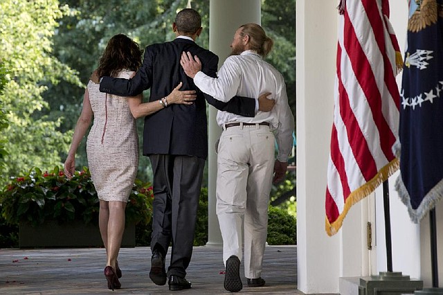 President Barack Obama walks with Jani Bergdahl, left, and her husband Bob Bergdahl, right after he spoke about the release of their son, U.S. Army Sgt. Bowe Bergdahl, in the Rose Garden of the White House in Washington, Saturday, May 31, 2014. Bergdahl, 28, had been held prisoner by the Taliban since June 30, 2009. He was handed over to U.S. special forces by the Taliban in exchange for the release of five Afghan detainees held by the United States. (AP Photo/Jacquelyn Martin)