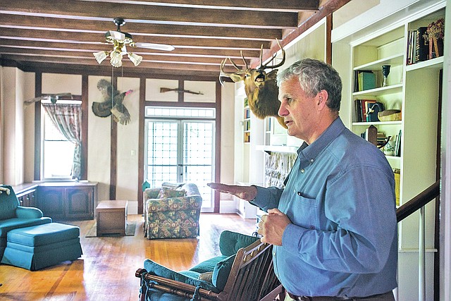 STAFF PHOTO ANTHONY REYES Springdale Mayor Doug Sprouse gives a brief tour of the Rabbit&#8217;s Foot Lodge on Thursday. The city recently bought the home and surrounding acreage. The land will be incorporated into nearby J.B. Hunt Park and the city is still trying to decide how to best use the home.