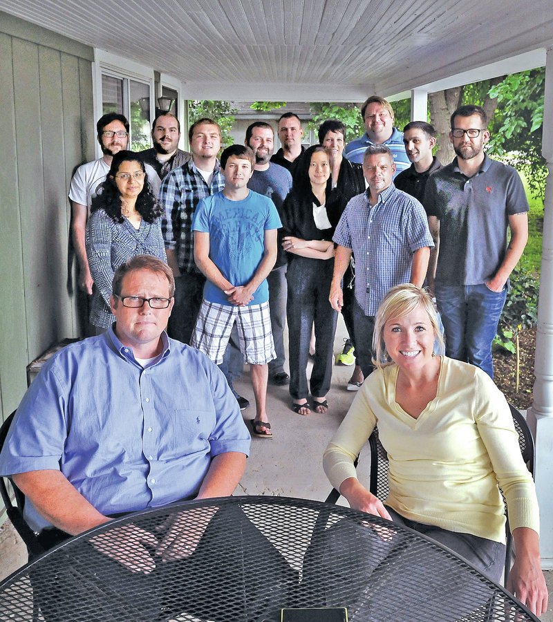 STAFF PHOTO BEN GOFF Movista co-founders April Seggebruch and Stan Zylowski with their staff in front of the business in Bentonville.