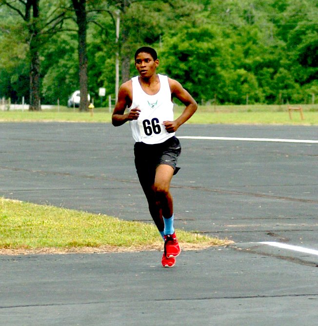 Photo by Mike Eckels Sammy Casey from Springdale rounds the corner of the runway and taxiway to begin his uphill climb during the Come Fly With Me 5k and color run at Crystal Lake Airport May 24. Casey won the race with a time of 18 minutes, 39 seconds.