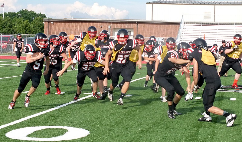 TIMES photographs by Annette Beard Blackhawk tailback Shane Ivy runs around the outside while linemen block for him during Friday night&#8217;s spring football game.