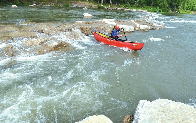 STAFF PHOTO Michael Woods &#8226; @NWAMICHAELW Arthur Bowie of Bentonville paddles his canoe around the second set of rapids Tuesday morning at the Siloam Springs Whitewater Recreation Park. For related video, go to nwaonline.com.