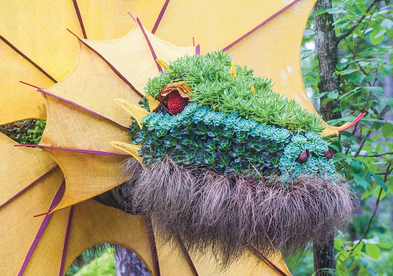 A dragon topiary with fiery red eyes is part of the new summer display, Mystic Creatures: Topiary Art Meets Imagination, at Garvan Woodland Gardens in Hot Springs.