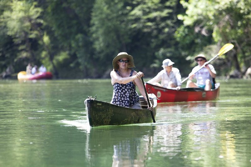 RYAN MCGEENEY/Arkansas Democrat-Gazette --06-03-2014-- Debbie Doss, conservation chair of the Arkansas Canoe Club, paddles down the Buffalo National River near Gilbert Tuesday morning. The club is part of a coalition of environmentally-oriented groups, including the National Parks Conservation Association and the Buffalo River Watershed Alliance, that has been trying to call attention to concerns over potential pollution to the river from a controversial Newton County hog farm.