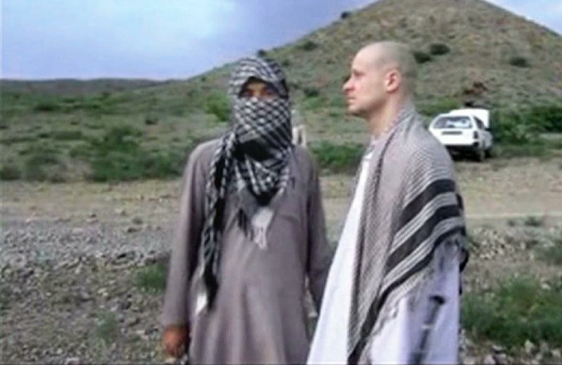 Sgt. Bowe Bergdahl (right) stands with a Taliban fighter, in this video released by the Taliban, as they wait Saturday in eastern Afghanistan for U.S. special forces to fly in and pick up Bergdahl as part of a swap for five Afghan detainees.