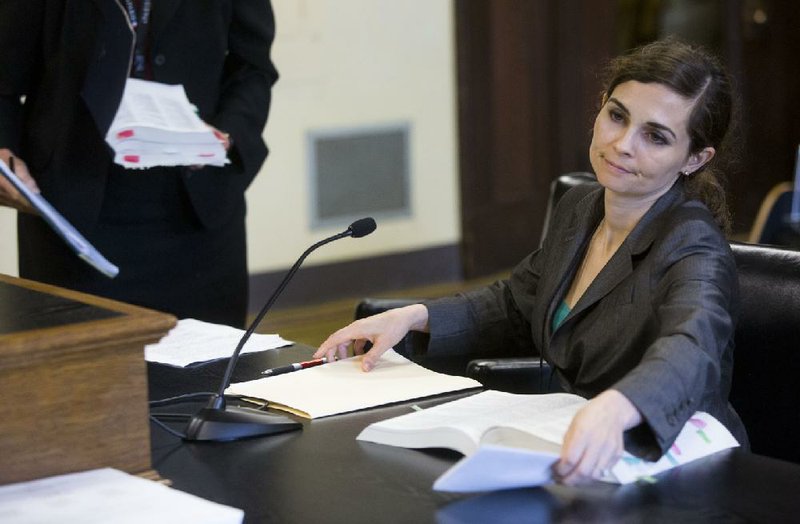 Christin Harper, an administrator at the state Department of Human Services, packs up on Wednesday after she and a colleague presented to the Senate Committee on Children and Youth an agency proposal that would allow more people to request removal from the state’s Child Maltreatment Central Registry.