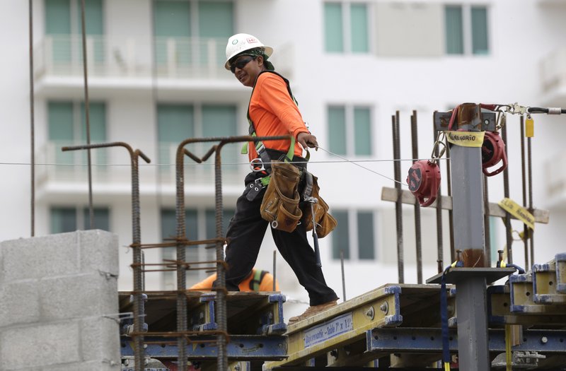 In this Friday, May 16, 2014 photo, a construction worker works on the site of the SoMa at Brickell apartment building in downtown Miami. The Institute for Supply Management, a trade group of purchasing managers, issues its index of non-manufacturing activity for May on Wednesday, June 4, 2014. 