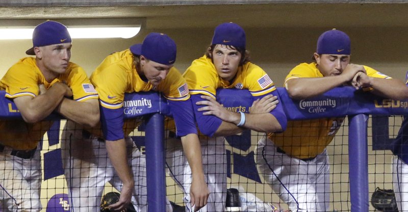 LSU players lean on the dugout during the final two outs of the ninth inning of an NCAA college baseball regional tournament game against Houston in Baton Rouge, La., Monday, June 2, 2014. Houston won 12-2.