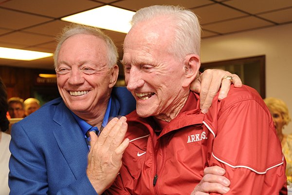 Jerry Jones, owner of the Dallas Cowboys and former Arkansas athlete, left, speaks alongside Frank Broyles, former coach and athletics director at the University of Arkansas, Friday, June 6, 2014, during the Frank and Barbara Broyles Foundation Caregivers United inaugural benefit golf scramble at Paradise Valley Golf andÊAthletic Club in Fayetteville.
