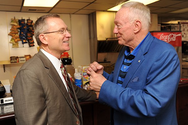 Jerry Jones, owner of the Dallas Cowboys and former Arkansas athlete, right, speaks with Jeff Long, athletics director at the University of Arkansas, Friday, June 6, 2014, during the Frank and Barbara Broyles Foundation Caregivers United inaugural benefit golf scramble at Paradise Valley Golf andÊAthletic Club in Fayetteville.