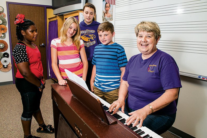 Bennie Dunavan, right, taught school for 25 years at a school in Monticello, and one of her former students, who performs in Nashville, got the ball rolling on a fundraiser for Mayflower choir students whose homes were destroyed in the April 27 tornado. Dunavan plays while students Autumn Fuller, from left, Zoey Hunt, Casey Murphy and Tyler Slye sing.