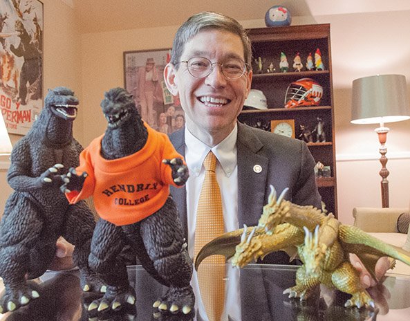 Hendrix College President Bill Tsutsui shows two of his many Godzilla figures, one of which is wearing a Hendrix College T-shirt, and Ghidorah, a three-headed monster from the Godzilla movies. Tsutsui, the author of a book on Godzilla, has his collection of Godzilla paraphernalia in his office. He said one of the most unusual is Godzilla with a clock in his stomach, and the one he treasures the most is a tin wind-up toy Godzilla.