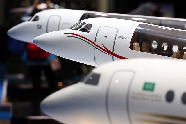 A model of a Falcon 900 LX aircraft, manufactured by Dassault Aviation SA, is seen on display during the 13th Dubai Airshow at Dubai World Central (DWC) in Dubai, United Arab Emirates, on Monday, Nov. 18, 2013. The 13th edition of the biennial 2013 Dubai Airshow, the Middle East's leading aerospace event organized by F&E Aerospace. Photographer: Duncan Chard/Bloomberg