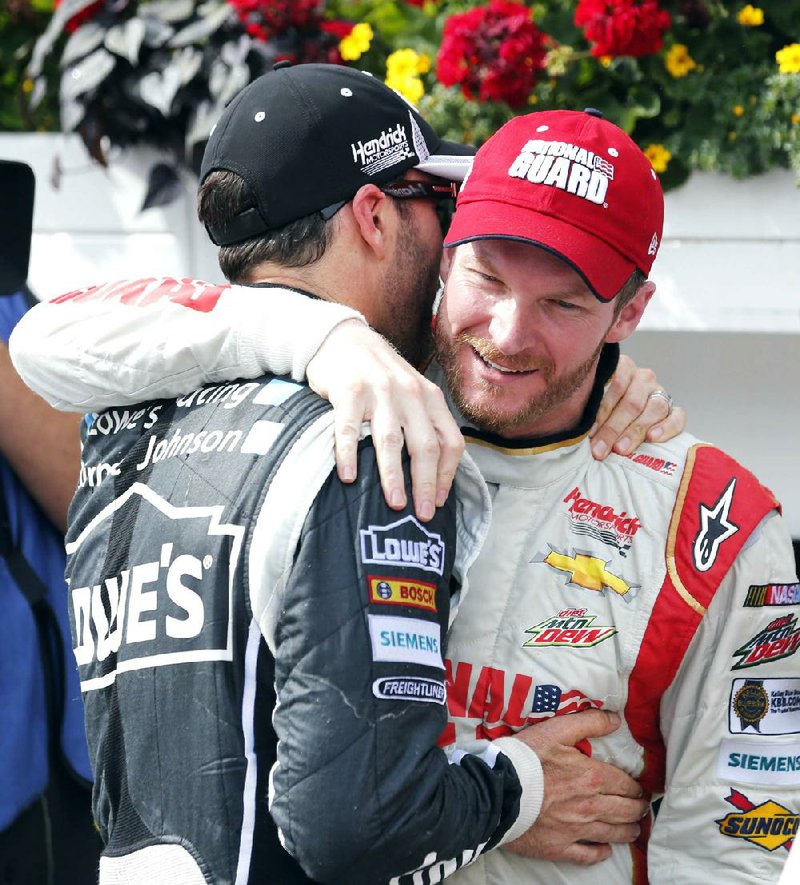 Dale Earnhardt Jr. (right) is congratulated by Jimmie Johnson after Sunday’s NASCAR Sprint Cup Pocono 400 in Long Pond, Pa. Johnson entered Sunday’s race with two consecutive victories, but finished sixth at Pocono. Earnhardt earned his second victory of the season.