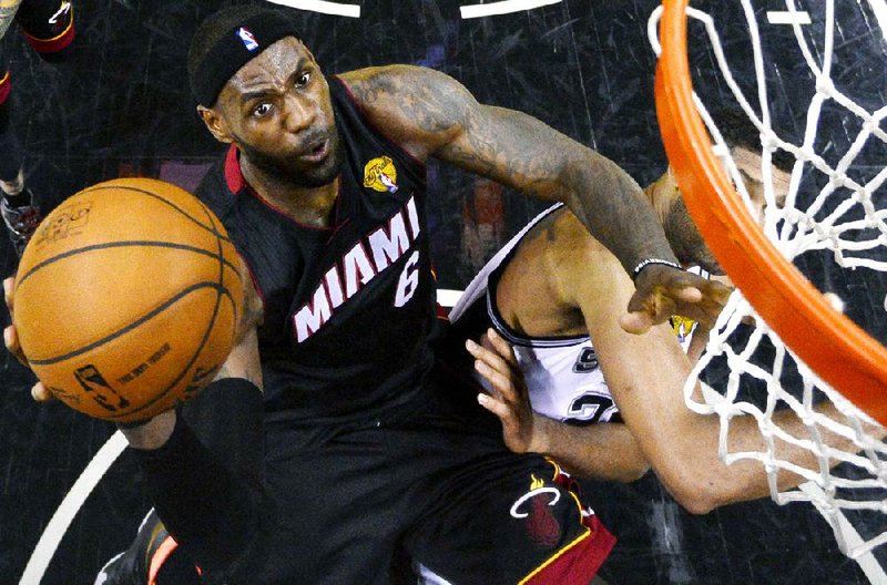 Miami Heat forward LeBron James shoots over San Antonio Spurs forward Tim Duncan during Game 2 of the NBA Finals in San Antonio. The Heat evened the best-of-7 series at 1-1 with a 98-96 victory.