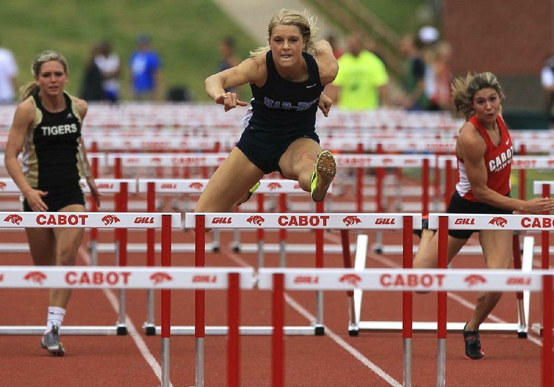 
Peyton Stumbaugh, center, from Springdale Har-Ber, set a new state overall record of 13.92 while competing in the Girls 110m Hurdles at the State 7A track championship Thursday in Cabot. Bentonville's Logan Morton, left, finished second, and Cabot's Tori Weeks, right, fell in the event.