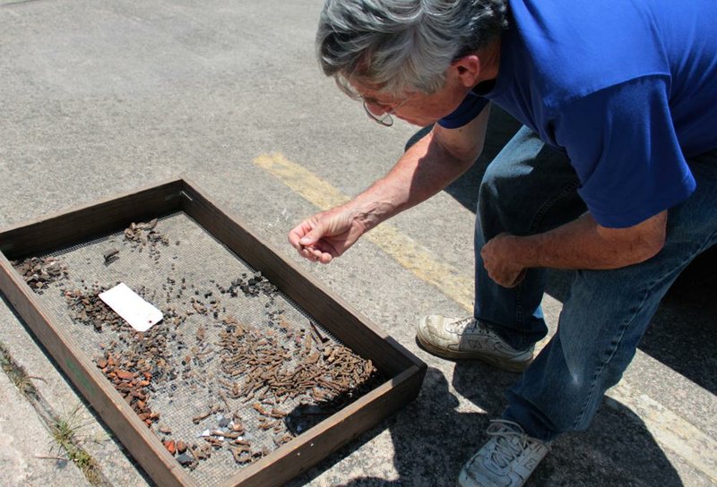 University of Arkansas System archaeologist John House, who is based at the University of Arkansas at Pine Bluff, looks through 19th century artifacts recently unearthed at a construction site near downtown Pine Bluff. The artifacts were discovered during the groundbreaking for a new water park.