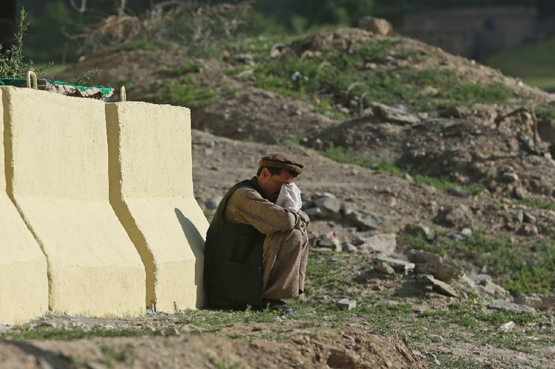 An Afghan man cries during presidential candidate Abdullah Abdullah’s visit of a flood-affected area in the Guzirga i-Nur district of Baghlan province, Afghanistan, on Sunday.