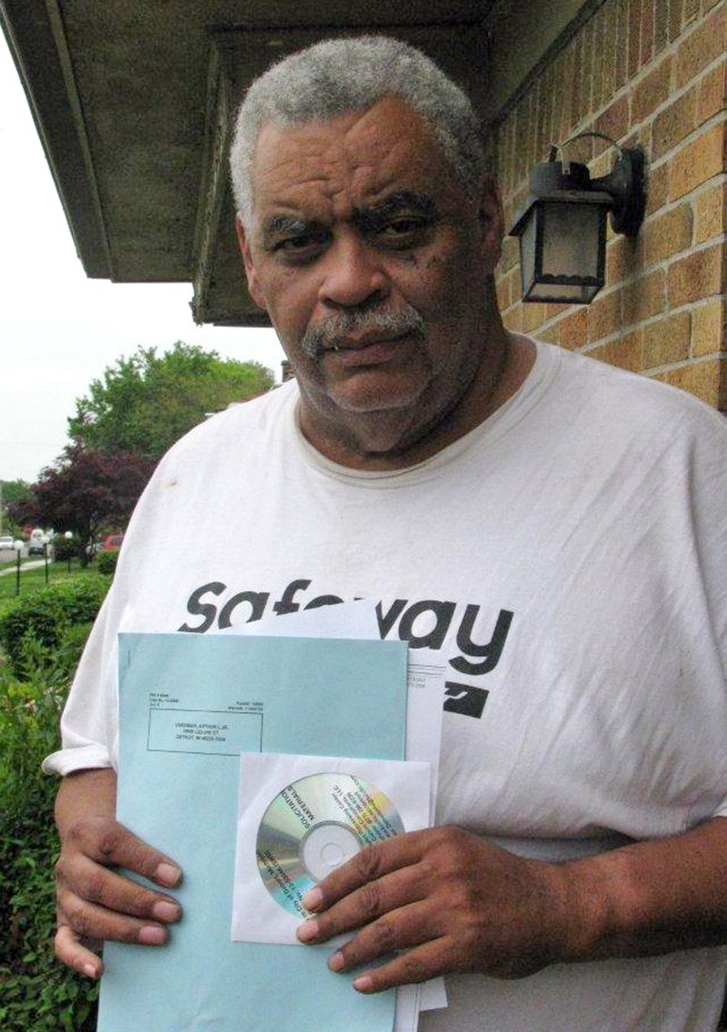 In this May 27, 2014 photo retired Detroit bus driver Art Vardiman holds a computer disk he received in the mail that holds hundreds of pages of documents, a six-page blue ballot about cuts to his pension and a white one on  health insurance in Detroit. Retirees with pensions at risk have until July 11 to vote on Detroits exit plan from bankruptcy.  General retirees like Vardiman would see a 4.5 percent cut in their pension and elimination of annual inflation payments. Police and fire retirees fare better. 